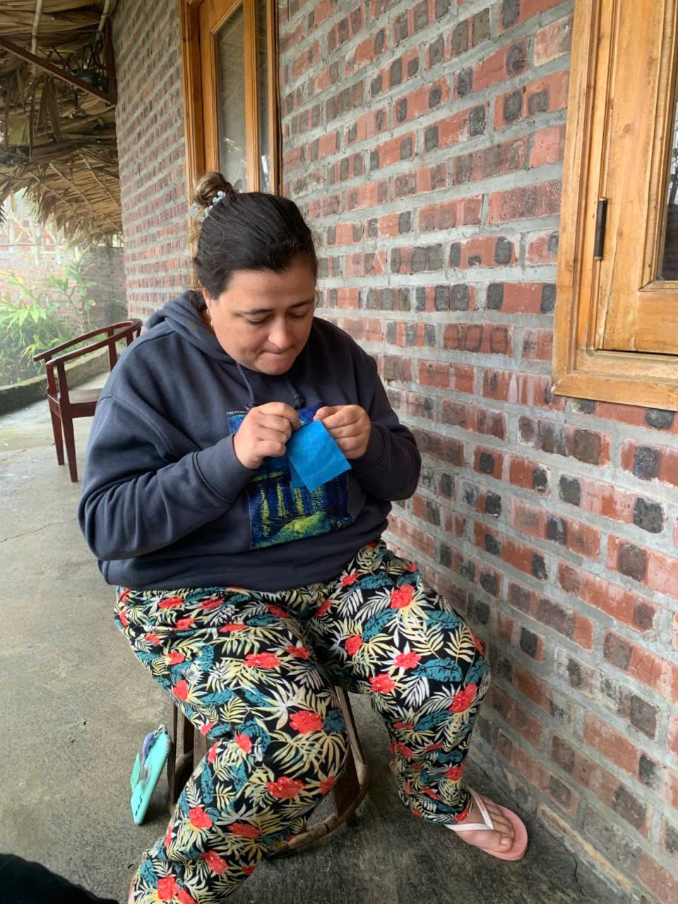 A guest practicing Hmong embroidery