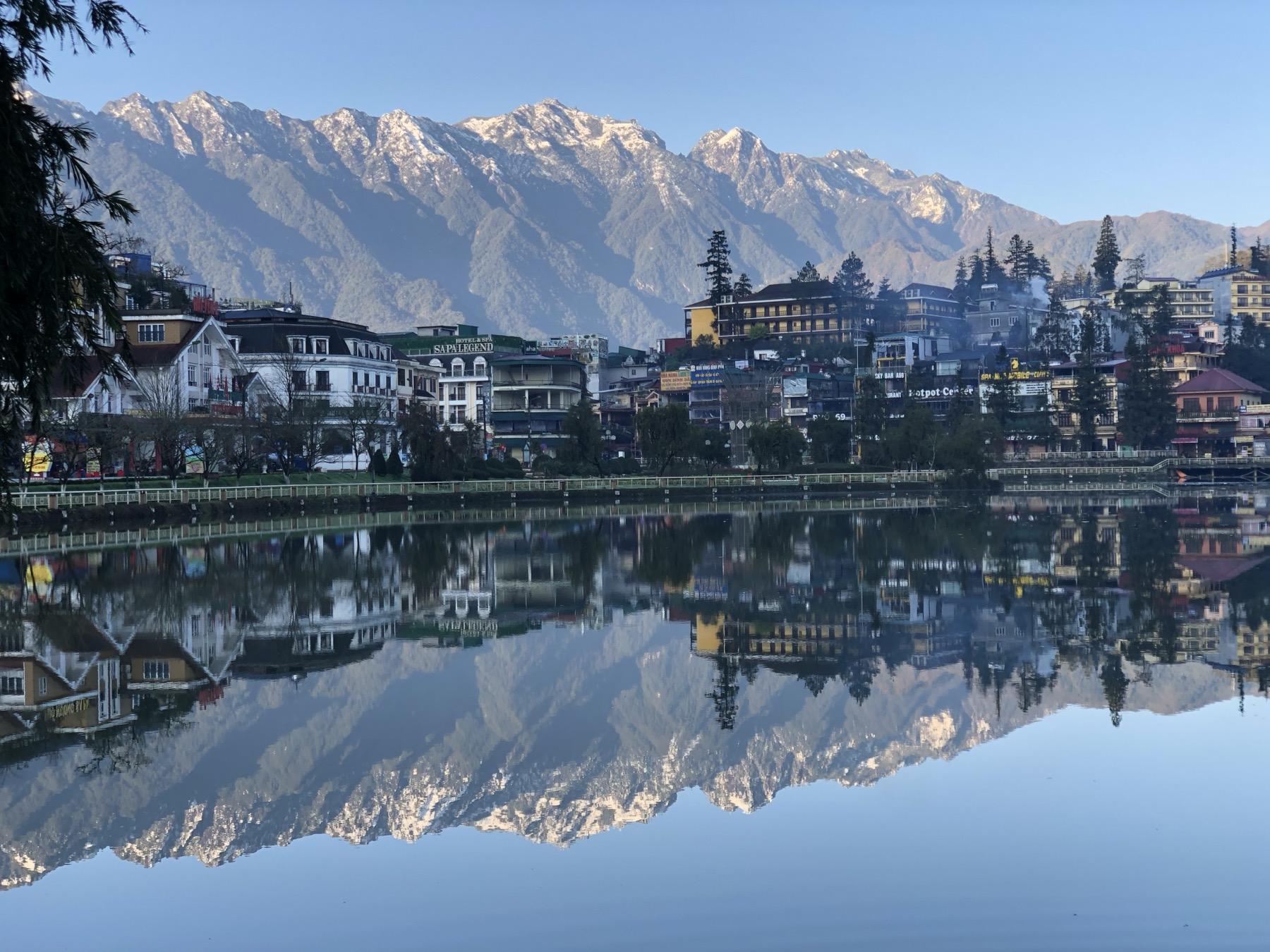 Sapa town lake with mountains reflected